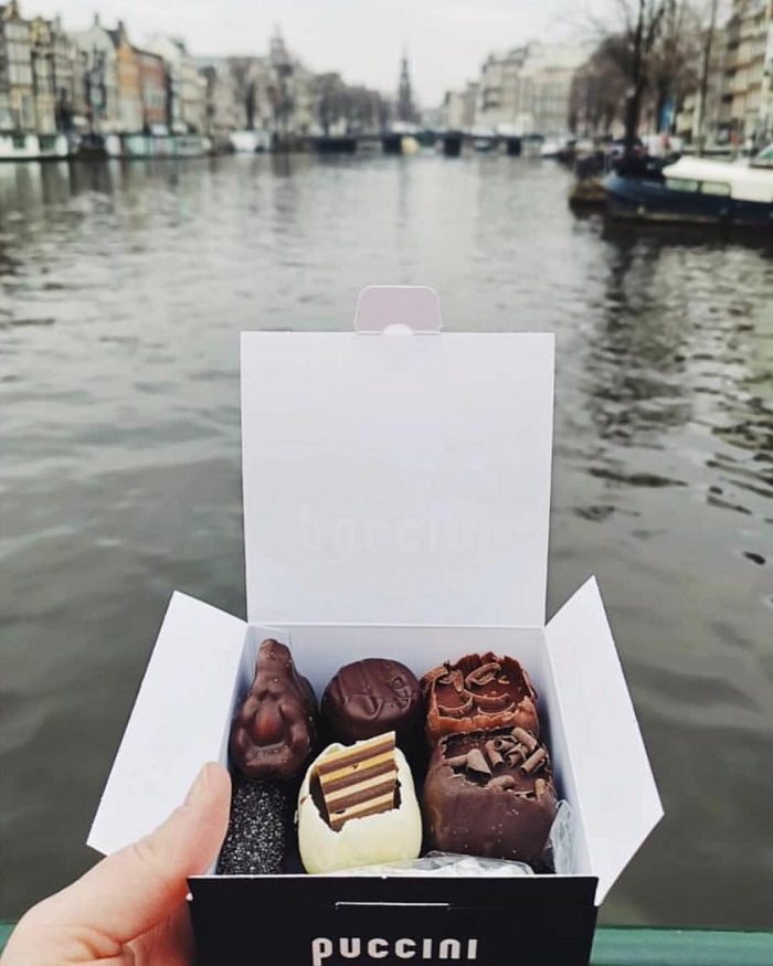 Enjoying a medium box of bonbons by the canal